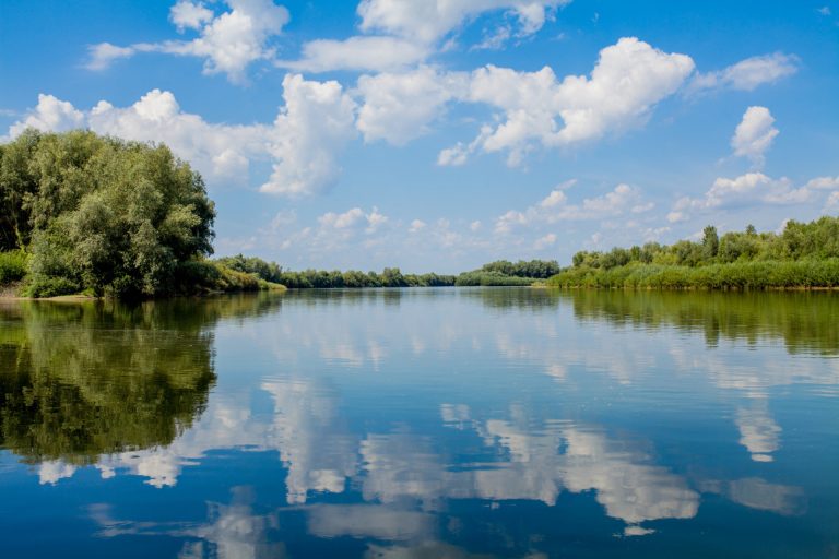 blue beautiful sky against river clouds are displayed calm water horizon green bank dniester place fishing