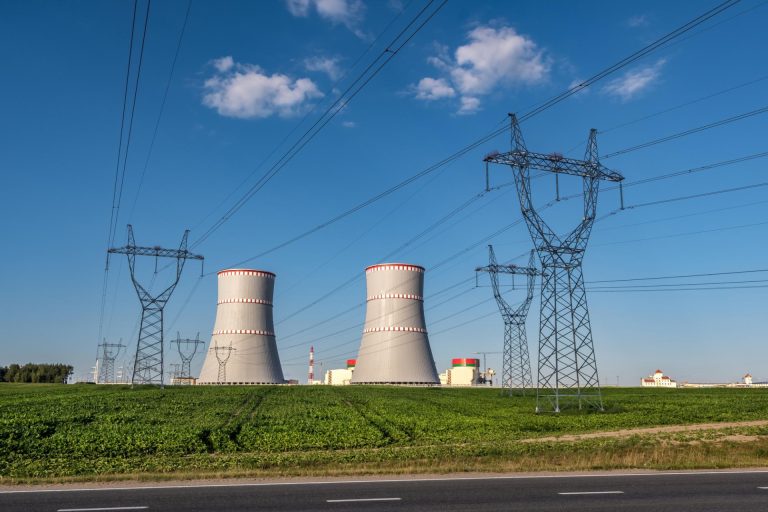 ostrovec belarus july 2020 cooling towers nuclear power plant with high voltage electric pylon towers against blue sky